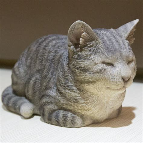 cat sleeping statue|orange tabby cat statue.